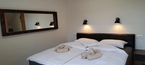 a bedroom with two beds with towels on them at Apartmaji Božiček Olimje in Podčetrtek