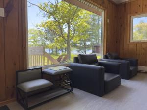 a living room with two couches and a window at 2-Bedroom Cottage #4 - Sand Bay in Dillon