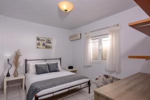 a bedroom with a bed and a window at Villa Anna Nina in Gouves - 3BD Retreat - Sleeps 8 in Kato Gouves