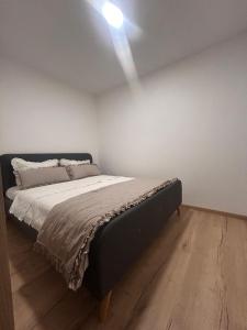 a bedroom with a bed with a light on the ceiling at Apartman Pervan in Čapljina