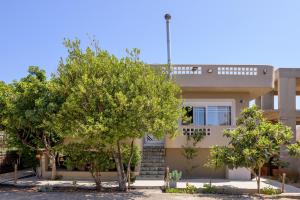 a house with trees in front of it at Villa Anna Nina in Gouves - 3BD Retreat - Sleeps 8 in Kato Gouves