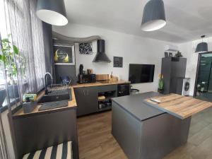a kitchen with a counter and a sink and a stove at Best City Green in Craiova