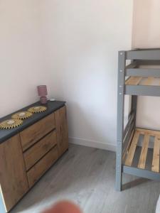 a room with a bunk bed and a desk with a ladder at appt 8 pers tout confort 4 in Laveissière