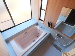 a large bathroom with a tub and a sink at 聖翔庵 in Tsumagoi +38 photos