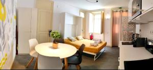 a small apartment with a bed and a table and chairs at Casa do Sapalinho I - Setubal Downtown in Setúbal