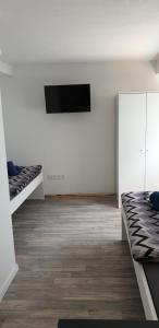 a room with two beds and a flat screen tv at Monteurzimmer A Simon in Jülich