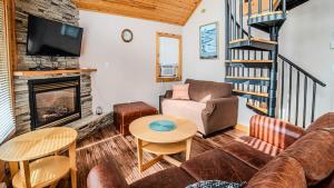a living room with a couch and a fireplace at Muskoka Lakefront 3-bdrm Chalet #90 in Port Carling