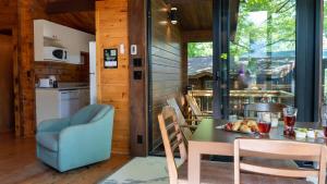 a kitchen and dining room with a table and chairs at Lake Muskoka 3-bdrm Cottage - Pier 100 #70 in Port Carling
