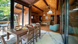 a dining room and living room with a table and chairs at Lake Muskoka 3-bdrm Cottage - Pier 100 #70 in Port Carling