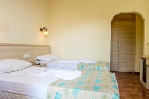 Postel nebo postele na pokoji v ubytování Magic Tulip Hotel