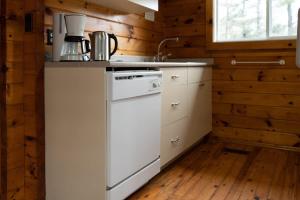 a kitchen with a white stove and a sink at Lake Muskoka Deluxe 3-bdrm Cottage - Pier 100 #80 in Port Carling +25 photos