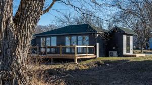 a small house with a porch and a deck at 2-bedroom Lake Front Cottage in Harwood ON #2 in Harwood