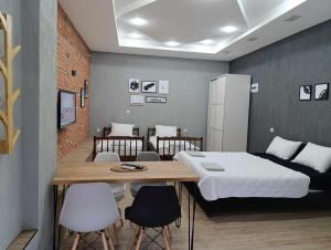 a room with a bed and a table and chairs at Apartment Sekulovski in Ohrid