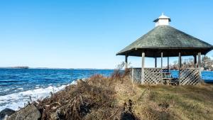 a gazebo on the side of the ocean at 2-bedroom Lake Front Cottage in Harwood ON #1 in Harwood