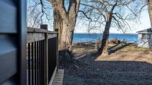a wooden fence with a view of the water at 2-bedroom Lake Front Cottage in Harwood ON #1 in Harwood +19 photos