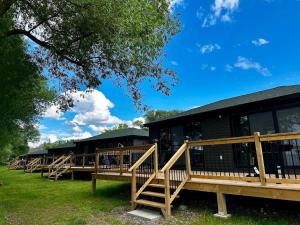 a row of wooden decks in front of a building at 2-bedroom Lake Front Cottage in Harwood ON #7 in Harwood