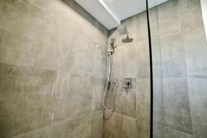 a shower with a glass door in a bathroom at 1-bedroom Townhouse in Harwood #5 in Harwood
