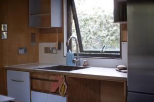 a kitchen with a sink and a window at Quinta do Luzio in Sintra