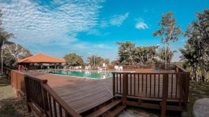 a wooden deck with a pool and a gazebo at Chalé em Barreirinhas com Piscina e Cozinha - Refúgio da Vicky nos Lençóis Maranhenses in Barreirinhas