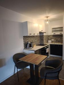 a kitchen with a wooden table and two chairs at Feriewohnung Alexandra in Bad Neuenahr-Ahrweiler +4 photos