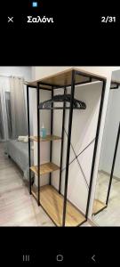 a black book shelf in a room with a bed at cris in volos in Volos