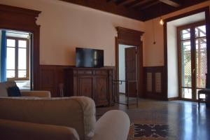 a living room with a couch and a flat screen tv at Residenza 1898 in Rocca di Papa