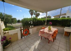 a table and chairs on a patio under an umbrella at Villa Sette Nani in Torre Lapillo