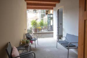 a room with chairs and a balcony with a fence at Da ME in Aosta