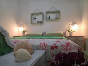 a bedroom with a bed and two mirrors on the wall at Villa Sette Nani in Torre Lapillo
