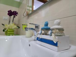 a bathroom sink with a soap dispenser on it at Villa Sette Nani in Torre Lapillo