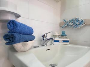 a blue towel sitting on a bathroom sink at Villa Sette Nani in Torre Lapillo