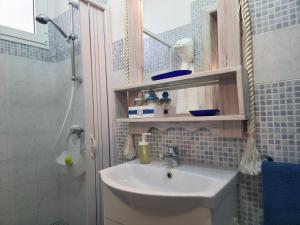 a bathroom with a sink and a shower at Villa Sette Nani in Torre Lapillo