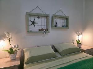 a bedroom with a bed and two windows at Villa Sette Nani in Torre Lapillo