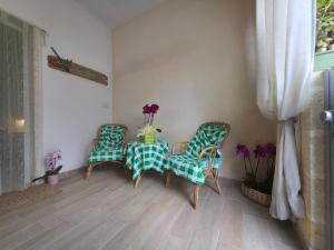 a dining room with a table and two chairs at Villa Sette Nani in Torre Lapillo