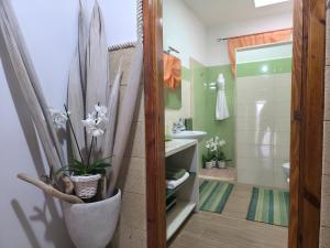 a bathroom with a sink and a toilet and a shower at Villa Sette Nani in Torre Lapillo