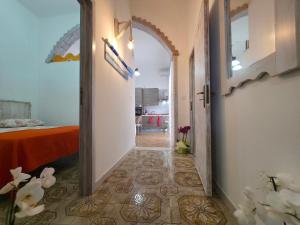 a hallway with a door to a room with a bed at Villa Sette Nani in Torre Lapillo