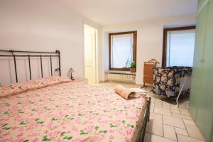 a bedroom with a large bed and a chair at Da ME in Aosta