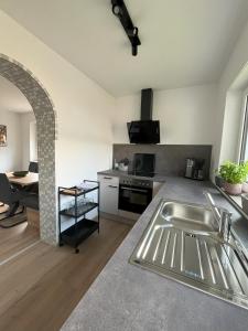 a kitchen with a sink and a stove at Ferienhaus Dorfblick in Günzburg