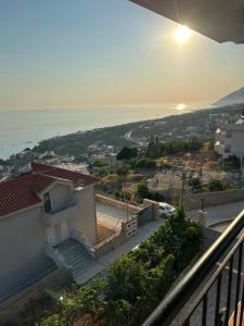 a view of a house with a view of the ocean at Guesthouse Mateo in Dhërmi