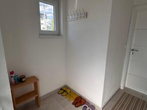 a room with a row of shoes on the floor at Vikendica Nuhanović - Vlašić in Vlasic