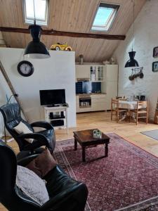 a living room with a couch and a table at Gîte La Sarrée in Onlay