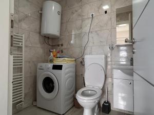 a bathroom with a washing machine and a toilet at Vikendica Nuhanović - Vlašić in Vlasic +29 photos
