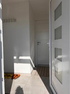 a room with a door and a pair of shoes at Vikendica Nuhanović - Vlašić in Vlasic