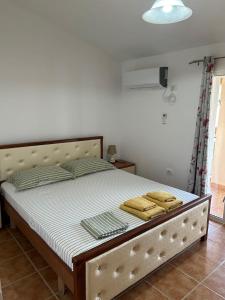 a bed in a room with two towels on it at Guesthouse Mateo in Dhërmi +49 photos