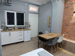 a kitchen with a table and chairs in a room at Apartment Sekulovski in Ohrid +9 photos