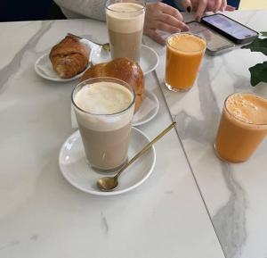 a table with three cups of coffee and a plate of food at VS LUXURY SUITE with SPA in Bari
