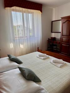 Postel nebo postele na pokoji v ubytování Apartman Ostrea ***
