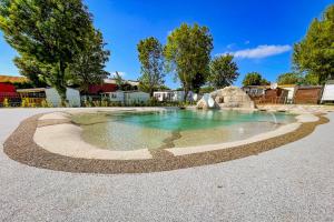 a pool with a water feature in a driveway at Petit Rio in Noyelles-sur-Mer