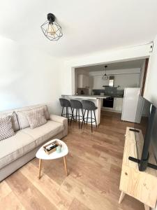 a living room with a couch and a table at Playa Del Sol Moderne Clim Vélo in Sainte-Marie-la-Mer