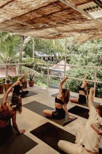 a group of women sitting in a yoga class at Armonia Santa Teresa in Santa Teresa Beach